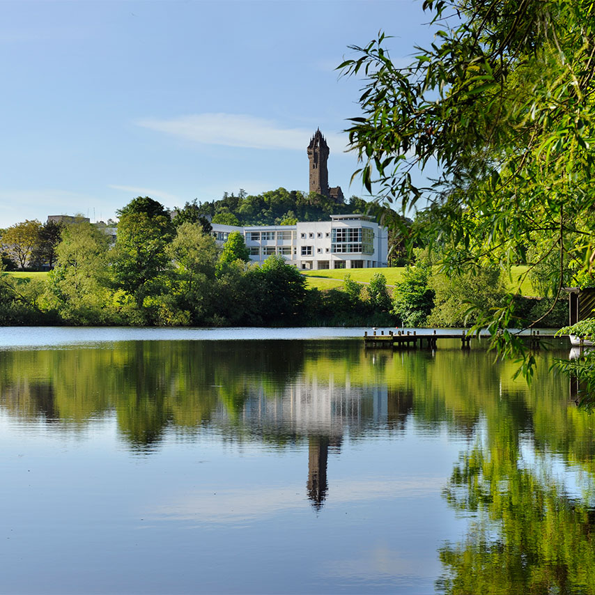 The University of Stirling campus across the loch, with the Wallace Monument behind